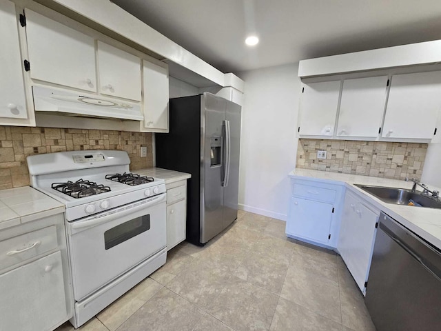 6363 Seven Springs Blvd Unit B, Greenacres, FL 33463 - kitchen with tasteful backsplash, a sink, light tile patterned flooring, appliances with stainless steel finishes, and under cabinet range hood