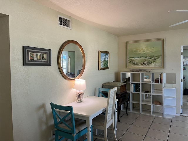 180 NE Lobster Rd, Port Saint Lucie, FL 34986 - tiled dining room featuring a textured wall, visible vents, and ceiling fan
