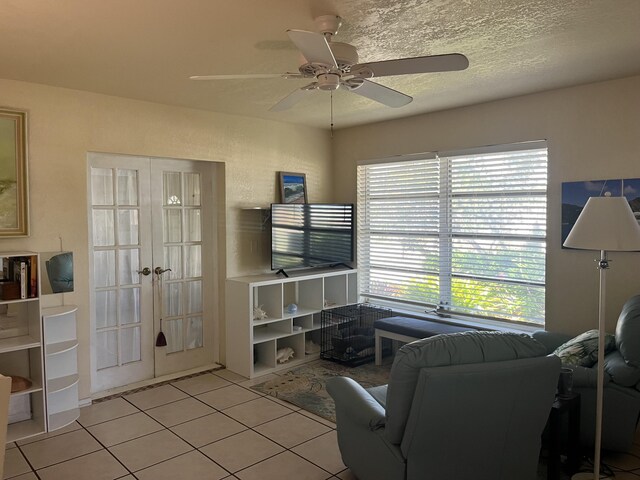 180 NE Lobster Rd, Port Saint Lucie, FL 34986 - living room featuring french doors, ceiling fan, and light tile patterned floors