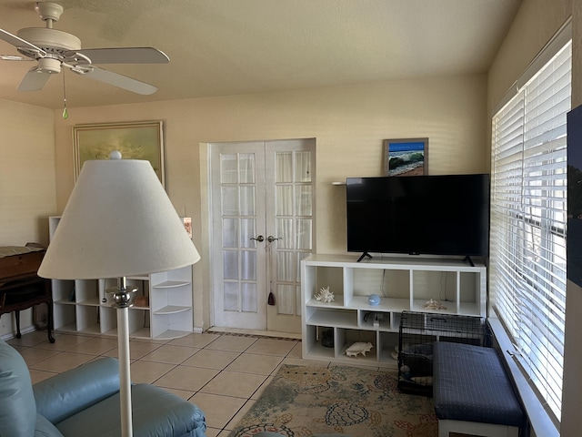 180 NE Lobster Rd, Port Saint Lucie, FL 34986 - tiled living room featuring ceiling fan and french doors