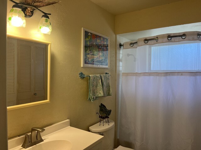 180 NE Lobster Rd, Port Saint Lucie, FL 34986 - bathroom with vanity, a textured wall, toilet, and a shower with curtain