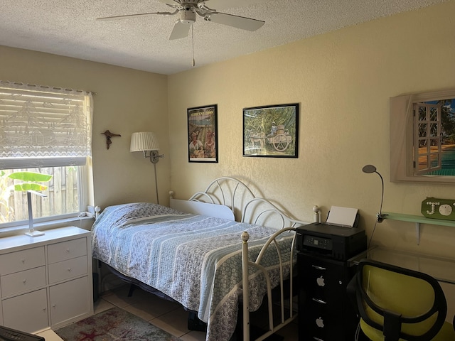 180 NE Lobster Rd, Port Saint Lucie, FL 34986 - bedroom featuring a textured ceiling, ceiling fan, and tile patterned floors