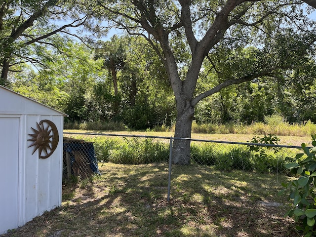 180 NE Lobster Rd, Port Saint Lucie, FL 34986 - view of yard with fence, an outdoor structure, and a shed
