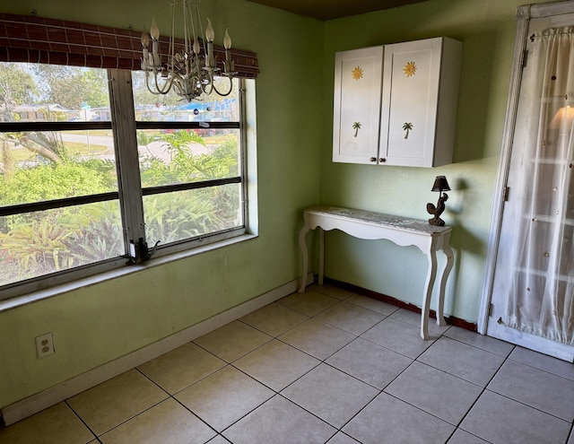 180 NE Lobster Rd, Port Saint Lucie, FL 34986 - unfurnished dining area with baseboards, light tile patterned flooring, and a chandelier