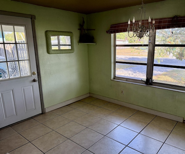 180 NE Lobster Rd, Port Saint Lucie, FL 34986 - unfurnished dining area with baseboards, light tile patterned floors, and a notable chandelier