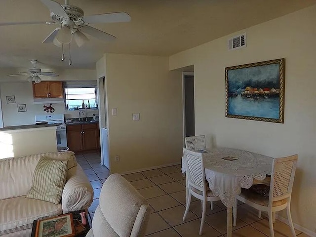 180 NE Lobster Rd, Port Saint Lucie, FL 34986 - dining room featuring baseboards, ceiling fan, visible vents, and light tile patterned floors