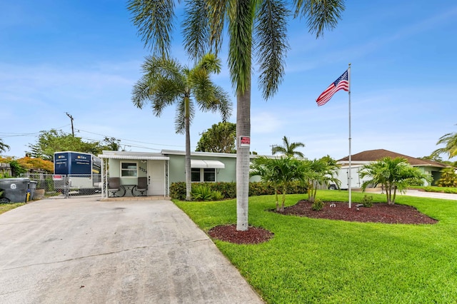5725 Basil Dr, West Palm Beach, FL 33415 - view of front facade with concrete driveway and a gate