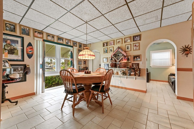 5725 Basil Dr, West Palm Beach, FL 33415 - dining area with a paneled ceiling, baseboards, and arched walkways