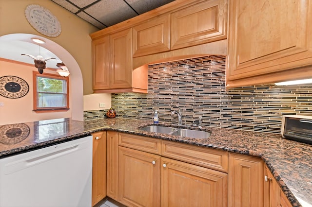 5725 Basil Dr, West Palm Beach, FL 33415 - kitchen featuring white dishwasher, a sink, decorative backsplash, dark stone counters, and light brown cabinets