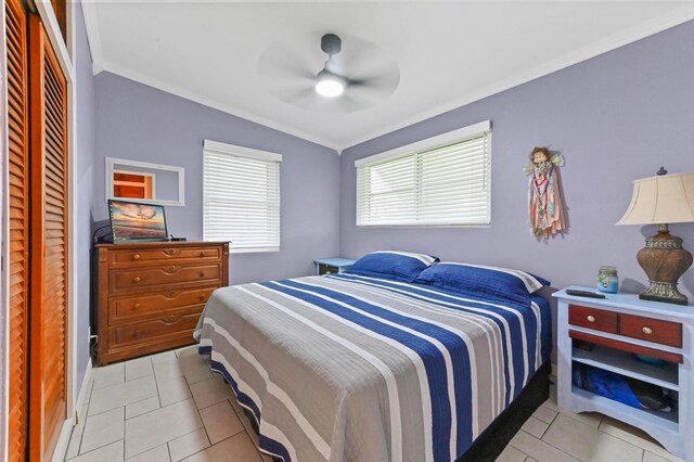 5725 Basil Dr, West Palm Beach, FL 33415 - bedroom featuring crown molding, light tile patterned flooring, a ceiling fan, baseboards, and a closet