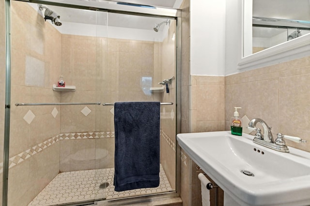 5725 Basil Dr, West Palm Beach, FL 33415 - full bathroom with a sink, a stall shower, and tile walls