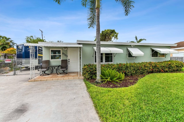 5725 Basil Dr, West Palm Beach, FL 33415 - view of front of house featuring stucco siding and a gate