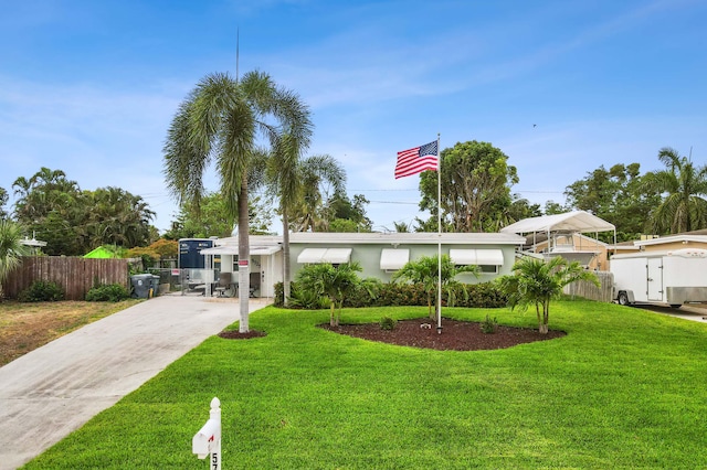5725 Basil Dr, West Palm Beach, FL 33415 - view of front facade with concrete driveway and stucco siding