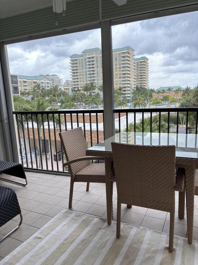balcony with a city view and ceiling fan