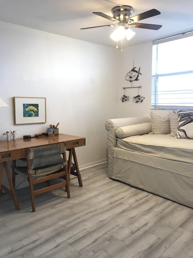 bedroom with baseboards, ceiling fan, and light wood finished floors