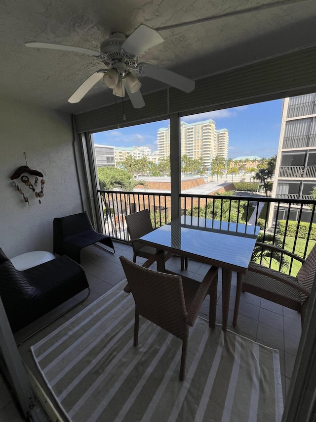 balcony with ceiling fan and a city view