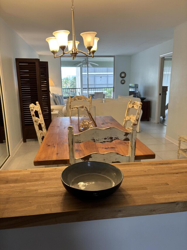 dining room with baseboards, light tile patterned floors, and a notable chandelier