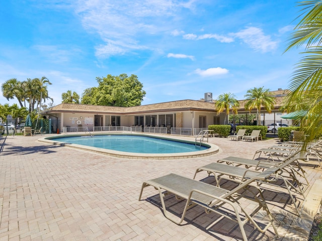 pool with fence and a patio