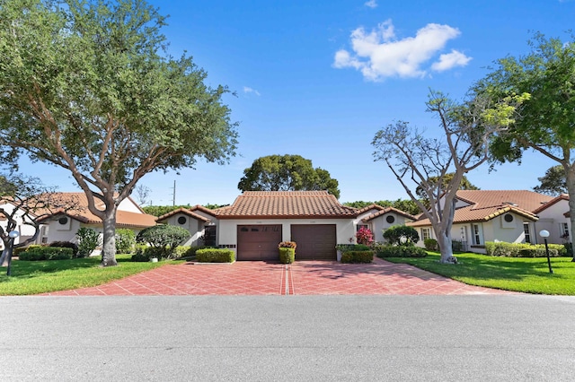 6040 Waldwick Cir, Delray Beach, FL 33484 - mediterranean / spanish-style home with a front yard, a tile roof, an attached garage, and driveway