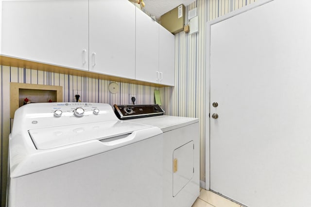 6040 Waldwick Cir, Delray Beach, FL 33484 - laundry area with washer and clothes dryer, wallpapered walls, and cabinet space
