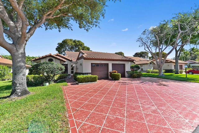 6040 Waldwick Cir, Delray Beach, FL 33484 - mediterranean / spanish home featuring stucco siding, driveway, an attached garage, a front lawn, and a tiled roof