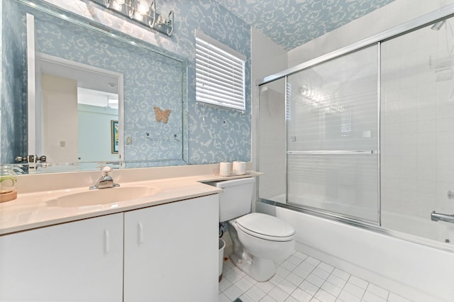 6040 Waldwick Cir, Delray Beach, FL 33484 - full bathroom with vanity, wallpapered walls, tile patterned flooring, toilet, and bath / shower combo with glass door