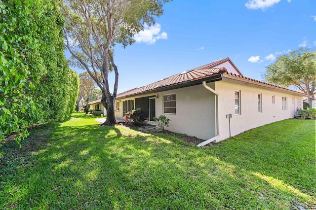 6040 Waldwick Cir, Delray Beach, FL 33484 - view of side of property with a yard, a tiled roof, and stucco siding