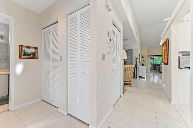 6040 Waldwick Cir, Delray Beach, FL 33484 - hallway with baseboards and light tile patterned flooring