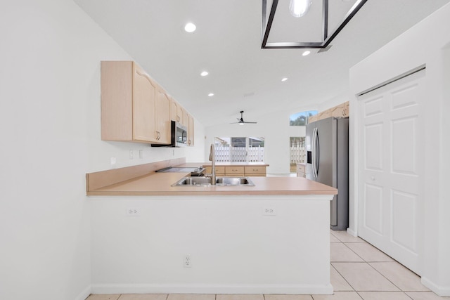 kitchen with light brown cabinets, a peninsula, light countertops, a ceiling fan, and appliances with stainless steel finishes