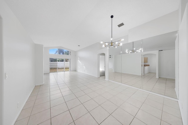 interior space with arched walkways, visible vents, an inviting chandelier, and lofted ceiling