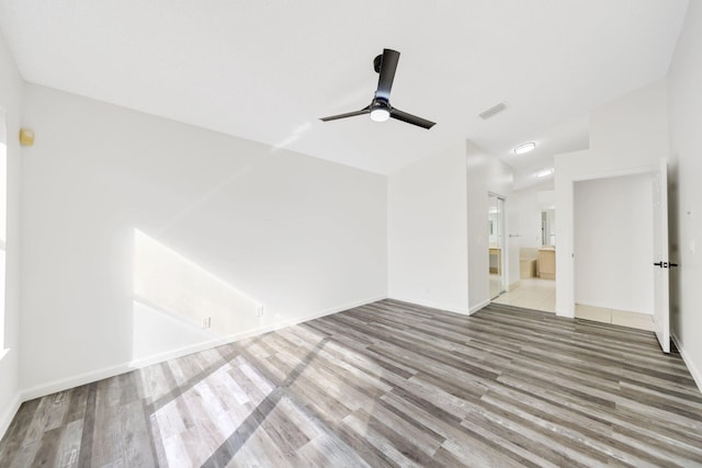 unfurnished living room featuring visible vents, baseboards, a ceiling fan, wood finished floors, and lofted ceiling