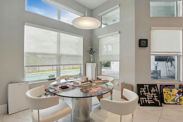 dining space featuring marble finish floor