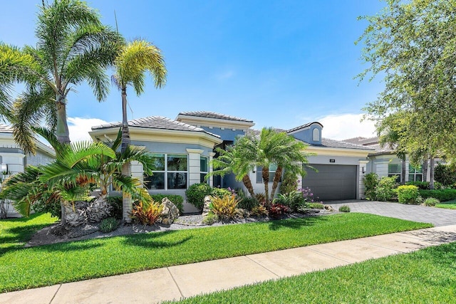 12797 Cariboo Ridge Rd, Boynton Beach, FL 33473 - mediterranean / spanish home featuring a garage, a front lawn, driveway, and stucco siding