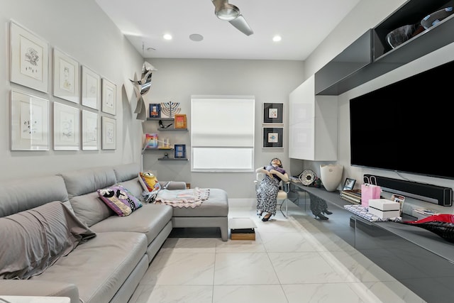 living area with recessed lighting and marble finish floor