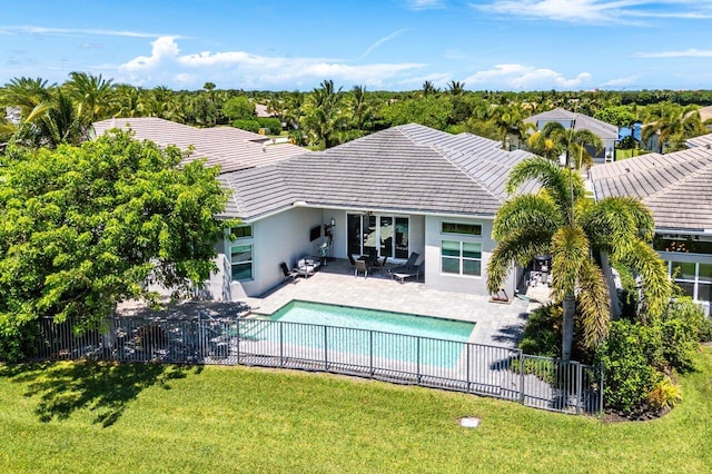 12797 Cariboo Ridge Rd, Boynton Beach, FL 33473 - back of property featuring a tiled roof, stucco siding, and a patio