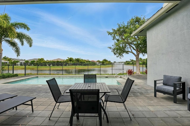 view of patio with a fenced backyard, a fenced in pool, and a water view