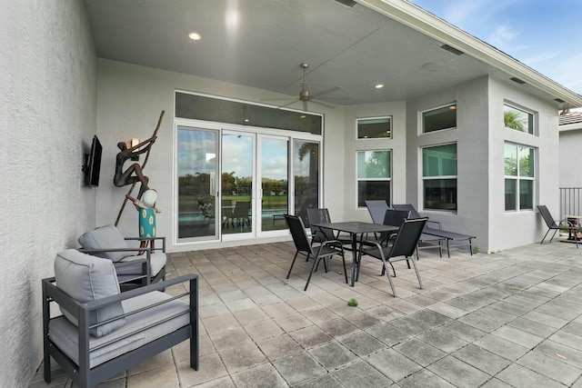 view of patio with a ceiling fan and outdoor dining area