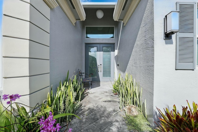 property entrance featuring french doors and stucco siding