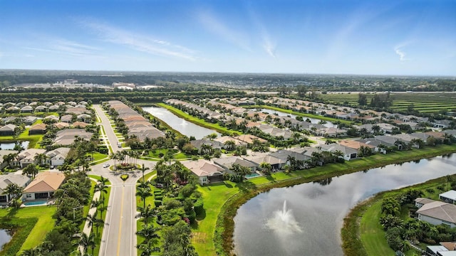 birds eye view of property featuring a water view and a residential view