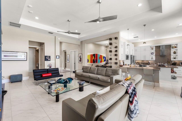 12797 Cariboo Ridge Rd, Boynton Beach, FL 33473 - living room with light marble finish floors, a tray ceiling, recessed lighting, and a ceiling fan