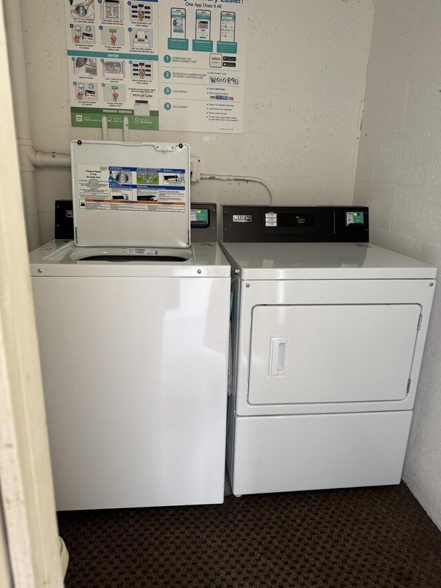 1225 NW 21st St Unit 410, Stuart, FL 34994 - shared laundry area featuring separate washer and dryer and concrete block wall