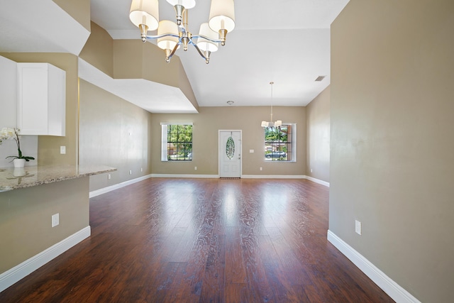 116 Churchill Dr, Royal Palm Beach, FL 33411 - interior space featuring vaulted ceiling, visible vents, wood finished floors, baseboards, and a chandelier