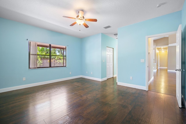 116 Churchill Dr, Royal Palm Beach, FL 33411 - spare room featuring dark wood-style floors, a textured ceiling, baseboards, visible vents, and a ceiling fan