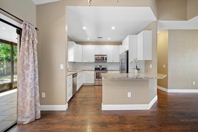 116 Churchill Dr, Royal Palm Beach, FL 33411 - kitchen featuring light stone counters, dark wood-style flooring, baseboards, and stainless steel appliances