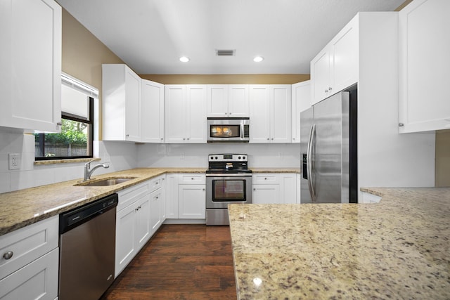 116 Churchill Dr, Royal Palm Beach, FL 33411 - kitchen with stainless steel appliances, a sink, recessed lighting, light stone counters, and dark wood-type flooring