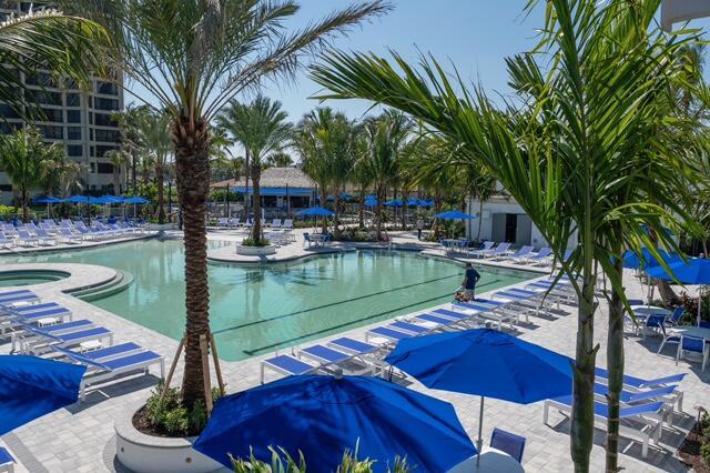 pool featuring a hot tub and a patio area