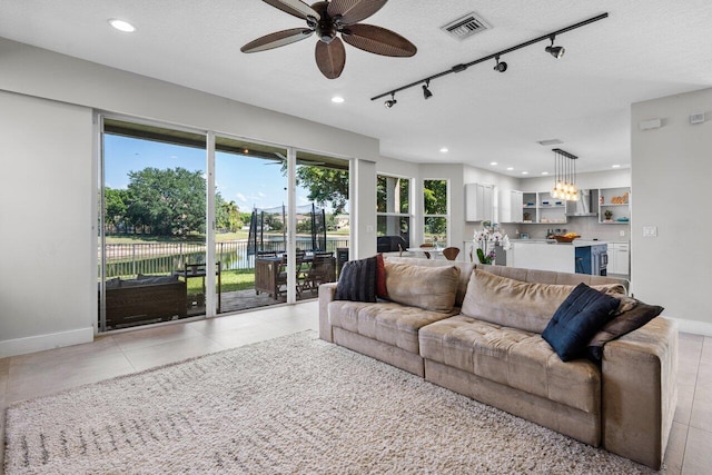 2261 Balsan Way, Wellington, FL 33414 - living area featuring recessed lighting, ceiling fan, a textured ceiling, baseboards, and light tile patterned flooring