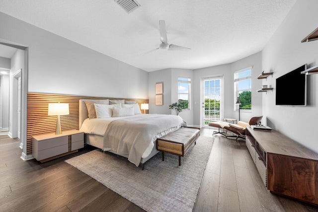 2261 Balsan Way, Wellington, FL 33414 - bedroom with access to outside, dark wood-style flooring, a textured ceiling, a ceiling fan, and baseboards