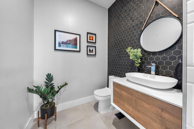 2261 Balsan Way, Wellington, FL 33414 - half bath featuring baseboards, tile patterned flooring, vanity, toilet, and tile walls