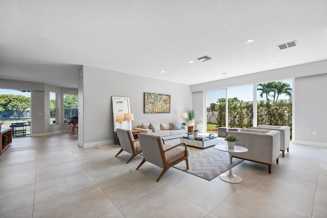 2261 Balsan Way, Wellington, FL 33414 - living room with a textured ceiling, light tile patterned floors, baseboards, and recessed lighting